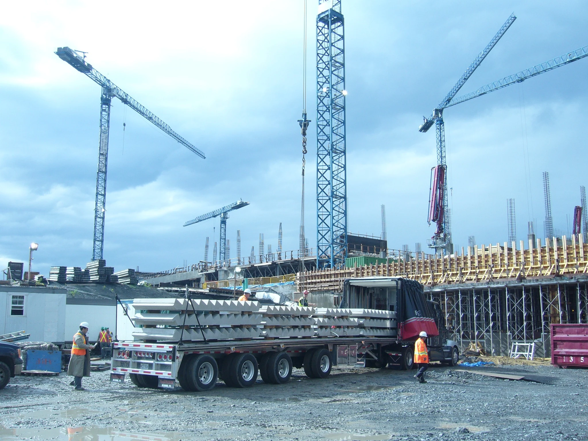 Worker attaching a precast concrete stair unit for hoisting.